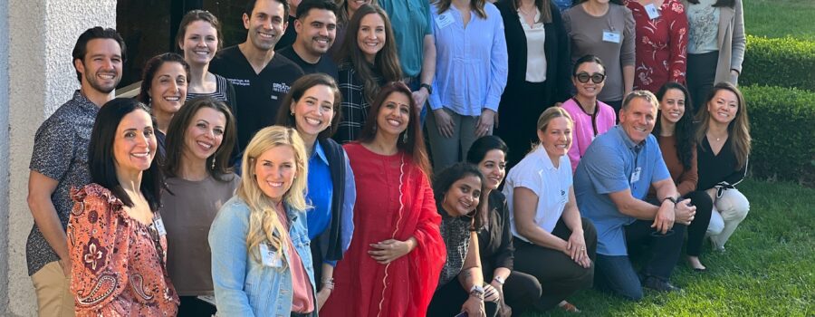 Attendees of a breathe institute seminar posing for a picture outside.